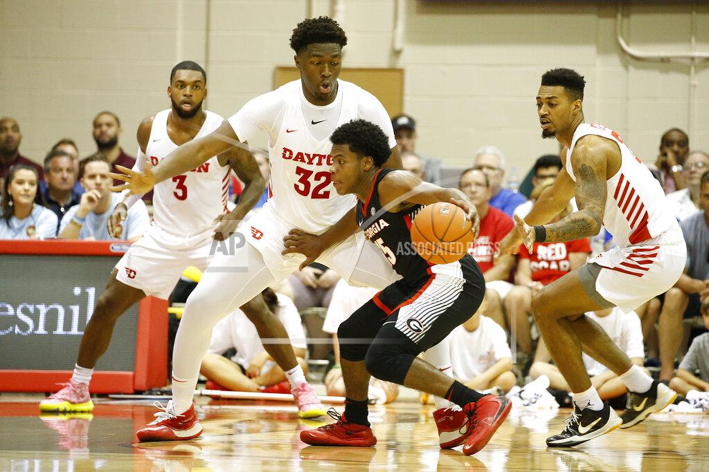 Marco Garcia Georgia guard Sahvir Wheeler (15) tries to find his way past Dayton guard Trey Landers (3), center Jordy Tshimanga (32), and guard Ibi Watson, right, during the first half of an NCAA college basketball game Monday, Nov. 25, 2019, in Lahaina, Hawaii. (AP Photo/Marco Garcia)