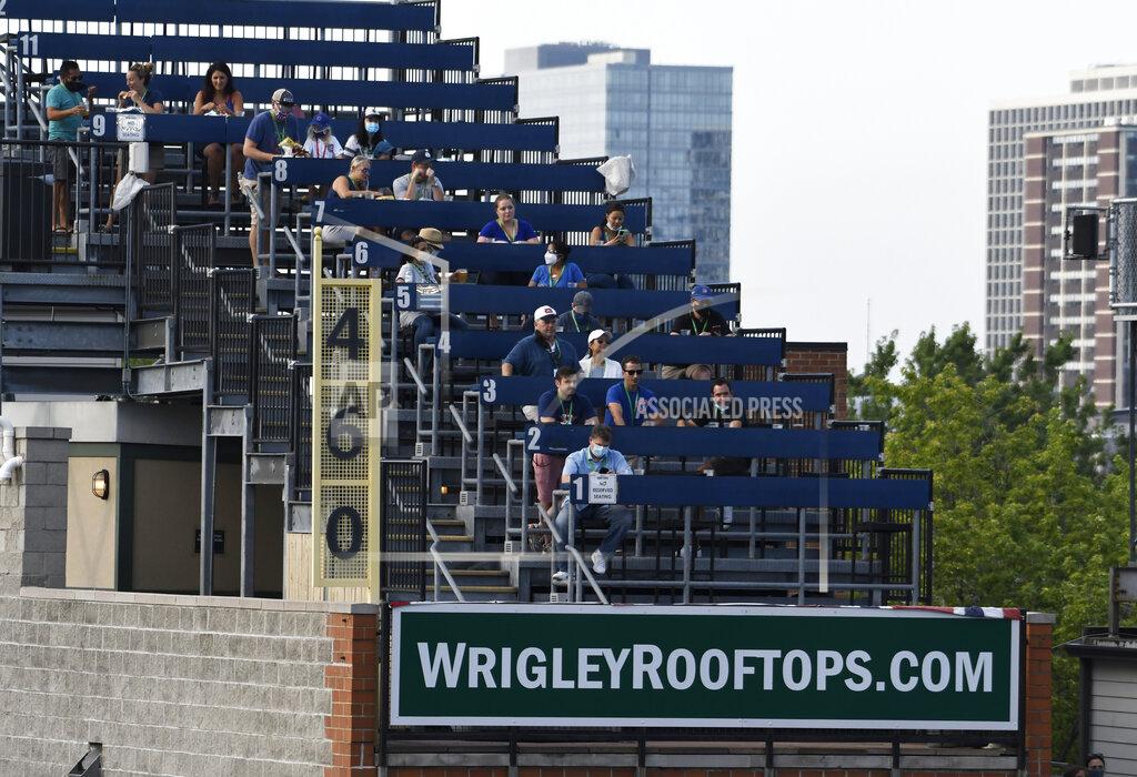David Banks Fans watch from the rooftops an opening day baseball game between the Chicago Cubs and the Milwaukee Brewers, Friday, July, 24, 2020, in Chicago. (AP Photo/David Banks)