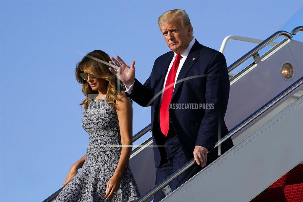 Evan Vucci President Donald Trump and first lady Melania Trump arrive at Andrews Air Force Base, Md., Wednesday, May 27, 2020, after traveling to Florida. (AP Photo/Evan Vucci)