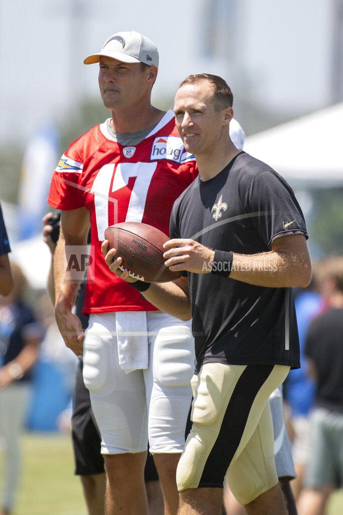 Los Angeles Chargers quarterback Philip Rivers, left, and New Orleans Saints quarterback Drew Brees look on during a joint NFL football practice in Costa Mesa, Calif., Thursday, Aug. 15, 2019. (AP Photo/Kyusung Gong)