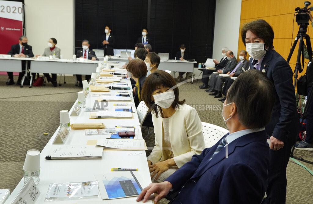 Kimimasa Mayaa Seiko Hashimoto, right, President of the Tokyo 2020 Organizing Committee of the Olympic and Paralympic Games, talks with newly appointed executive board member Naoko Takahashi, center, gold medalist of Sydney Olympic Games women's marathon, before Hashimoto delivers her opening remarks of the executive board meeting in Tokyo, Japan, Monday, March 22, 2021. The 12 new executive board members, who were appointed on March 3, made speech at the meeting. (Kimimasa Mayama/Pool Photo via AP)