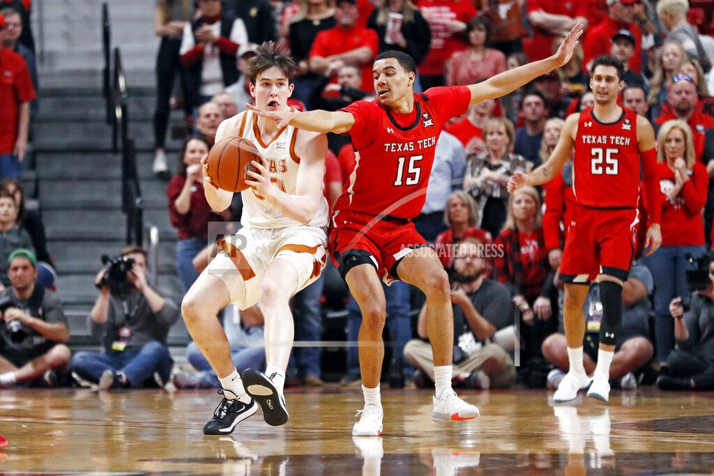 Brad Tollefson Texas Tech's Kevin McCullar (15) tries to steal the ball from Texas' Will Baker (50) during the first half of an NCAA college basketball game Saturday, Feb. 29, 2020, in Lubbock, Texas. (AP Photo/Brad Tollefson)