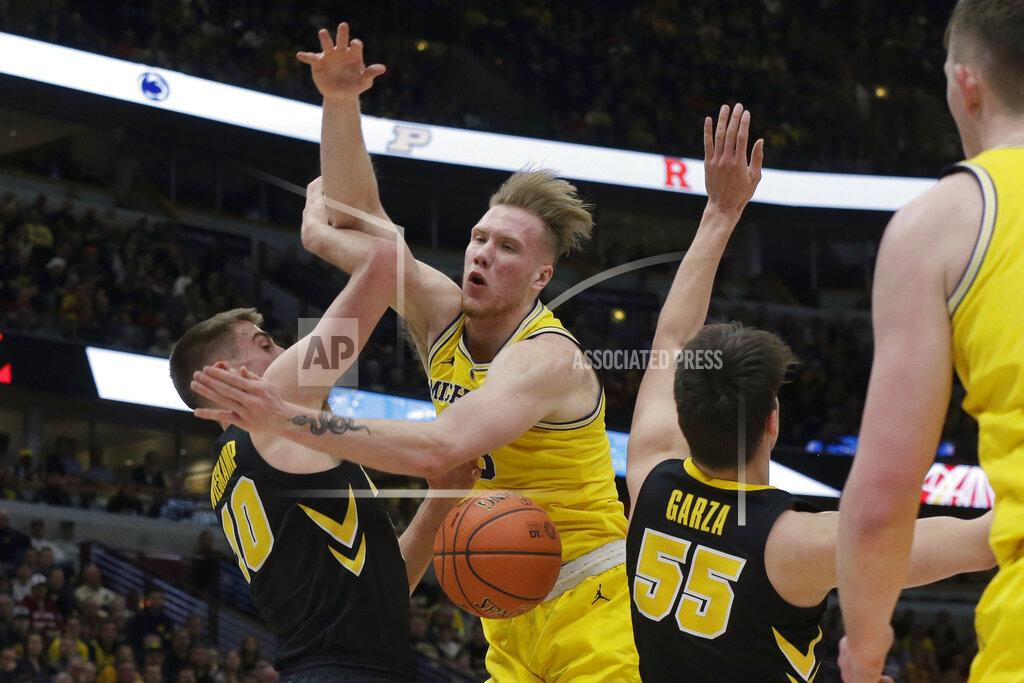 Kiichiro Sato Michigan's Ignas Brazdeikis is fouled by Iowa's Joe Wieskamp (10) during the first half of an NCAA college basketball game in the quarterfinals of the Big Ten Conference tournament, Friday, March 15, 2019, in Chicago. (AP Photo/Kiichiro Sato)