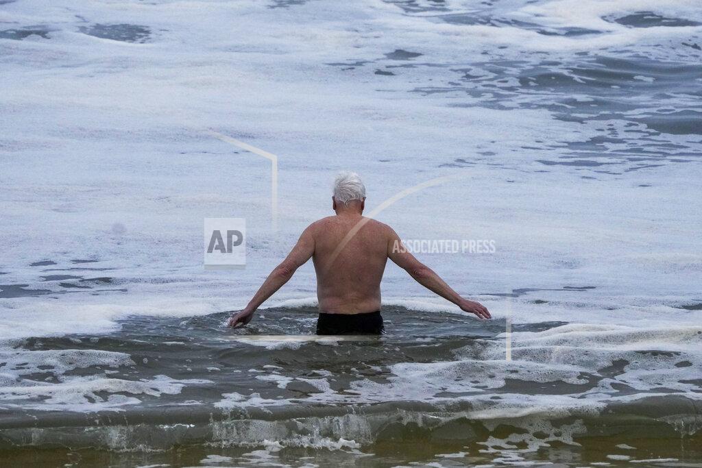 Mark Baker A man takes a mid-winter swim at Bronte Beach as rain continues to fall in Sydney, Australia, Wednesday, July 6, 2022. More than 50,000 residents of Sydney and its surrounds have been told to evacuate or prepare to abandon their homes on Tuesday as Australia's largest city braces for what could be its worst flooding in 18 months. (AP Photo/Mark Baker)