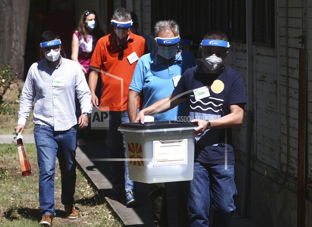 Boris Grdanoski Members of a special election team with a ballot box and voting material leave a municipal election commission headquarters on their way to voters who have tested positive for COVID-19 or are in self-isolation, in Skopje, North Macedonia on Monday, July 13, 2020. North Macedonia holds its first parliamentary election under its new country name this week, with voters heading to the polls during an alarming spike of coronavirus cases in the small Balkan nation. Opinion polls in the run-up to Wednesday’s vote indicate a close race between coalitions led by the Social Democrats and the center-right opposition VMRO-DPMNE party. (AP Photo/Boris Grdanoski)