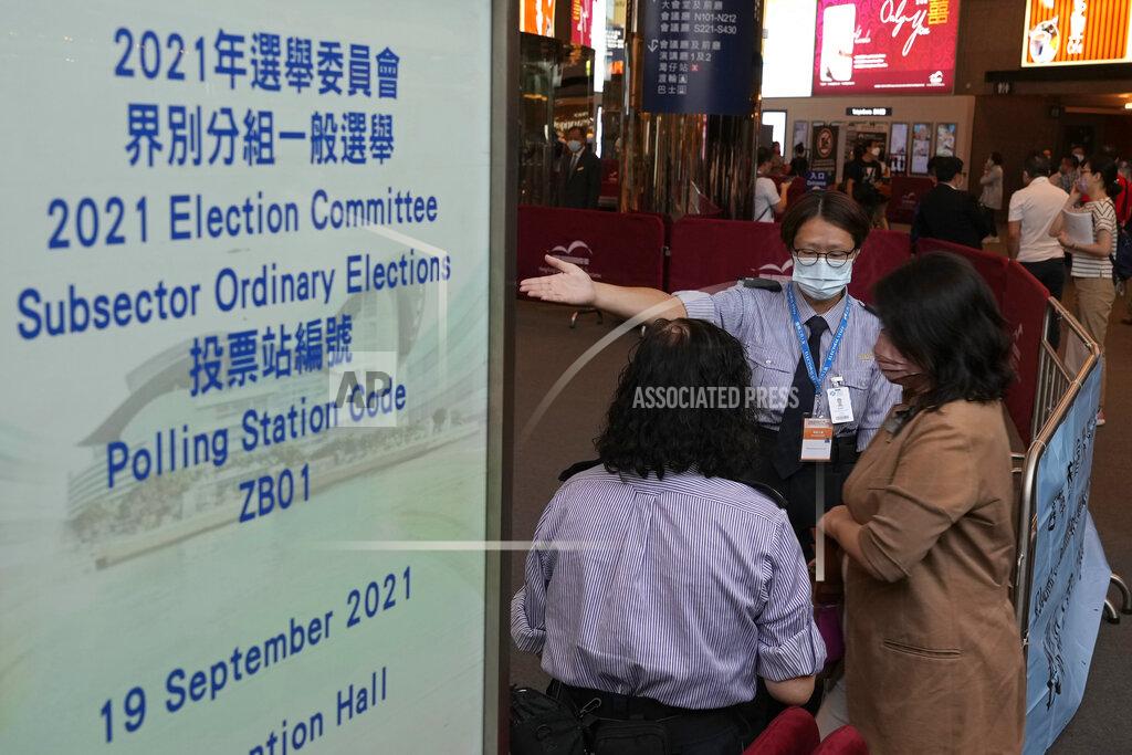 Vincent Yu Voters enter a polling center for the election committee that will vote for the city's leader in Hong Kong Sunday, Sept. 19, 2021. Hong Kong's polls for an election committee that will vote for the city's leader kicked off Sunday amid heavy police presence, with chief executive Carrie Lam saying that it is "very meaningful" as it is the first election to take place following electoral reforms. (AP Photo/Vincent Yu)