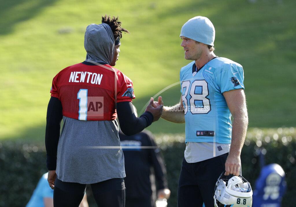 Chuck Burton Carolina Panthers quarterback Cam Newton (1) greets tight end Greg Olsen (88) during practice at the NFL football team's training camp in Spartanburg, N.C., Thursday, July 25, 2019. (AP Photo/Chuck Burton)