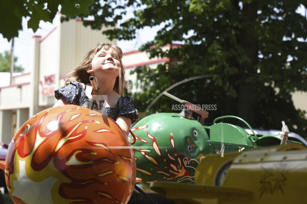 Don Campbell Leah Massey, 5, of Coloma, Mich., enjoys the sunshine as she takes a spin on one of the carnival rides Friday, June 11, 2021, during the opening of the Hartford Strawberry Festival, held at Ely Park in downtown Hartford, Mich.(Don Campbell/The Herald-Palladium via AP)