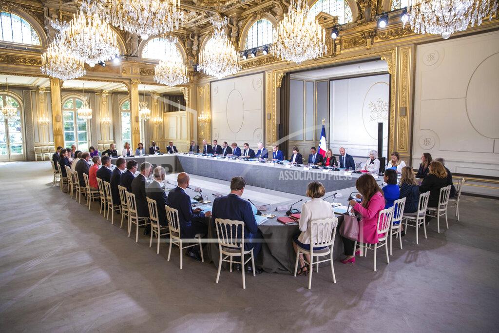 Christophe Petit Tesson French President Emmanuel Macron, center at right, chairs the first cabinet meeting with new ministers at the Elysee Palace in Paris, Monday, July 4, 2022. French President Emmanuel Macron rearranged his Cabinet on Monday in an attempt to adjust to a new political reality following legislative elections in which his centrist alliance failed to win a majority in the parliament. (Christophe Petit Tesson, Pool via AP)