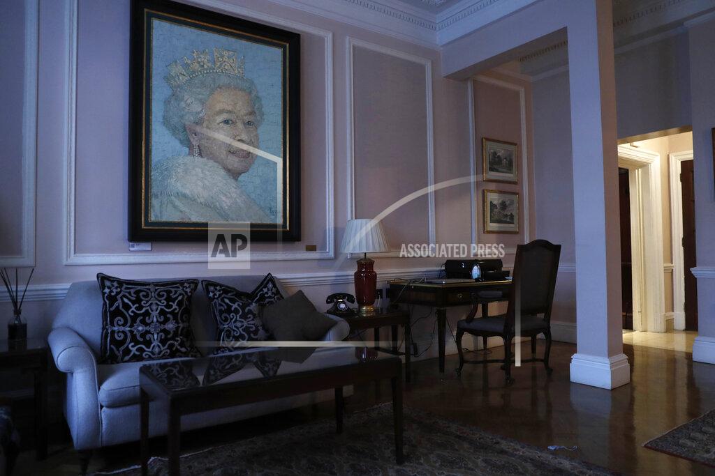 A painting of Britain's Queen Elizabeth II hangs in the reception area of the Stafford hotel near central London's St. James's Palace, Thursday, March 4, 2021. (AP Photo/Alastair Grant)