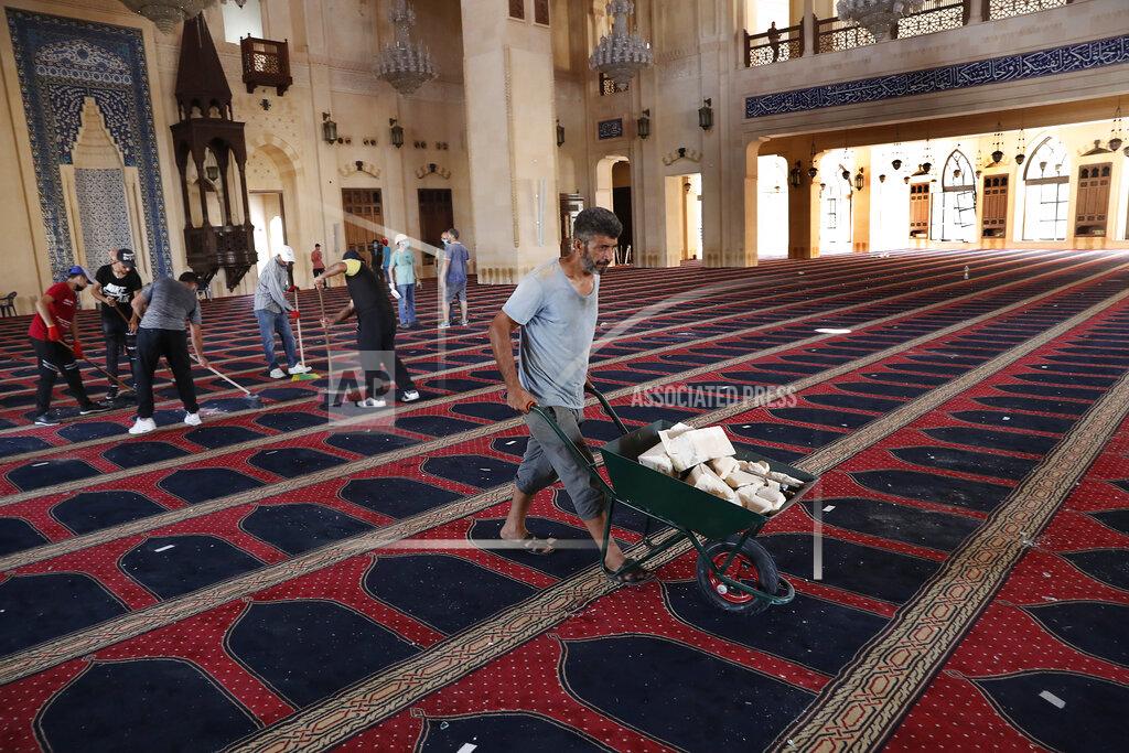 Hussein Malla People clean a damaged mosque a day after an explosion hit the seaport of Beirut, Lebanon, Wednesday, Aug. 5, 2020. Residents of Beirut confronted a scene of utter devastation on Wednesday, a day after a massive explosion at the port rippled across the Lebanese capital, killing at least 100 people, wounding thousands and leaving entire city blocks flooded with glass and rubble. (AP Photo/Hussein Malla)
