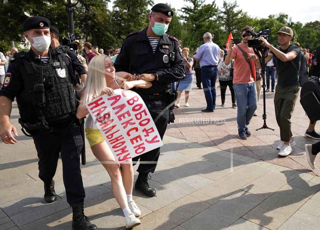 Alexander Zemlianichenko FILE - In this Aug. 14, 2021, file photo, Russian police detain an opposition activist with a poster reading "Freedom to Alexei Navalny" during an anti-vaccination protest in the center of Moscow, Russia. Imprisoned Russian opposition leader Navalny and his embattled allies won't be running in the Sept. 19 parliamentary election, but they still hope to challenge the ruling United Russia party with their strategy known as Smart Voting. (AP Photo/Alexander Zemlianichenko, File)