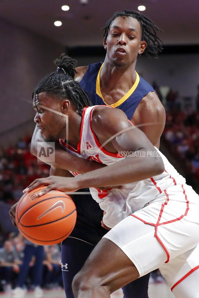 Michael Wyke Houston forward Jarace Walker, left, tries to drive around Northern Colorado forward Bryce Kennedy, right, during the second half of an NCAA college basketball game Monday, Nov. 7, 2022, in Houston. (AP Photo/Michael Wyke)