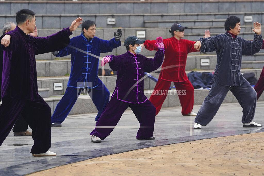 Ng Han Guan Residents practice tai chi at a park in Wuhan in central China's Hubei Province on Saturday, Jan. 23, 2021. A year after it was locked down to contain the spread of coronavirus, the central Chinese city of Wuhan has largely returned to normal, even as China continues to battle outbreaks elsewhere in the country. (AP Photo/Ng Han Guan)