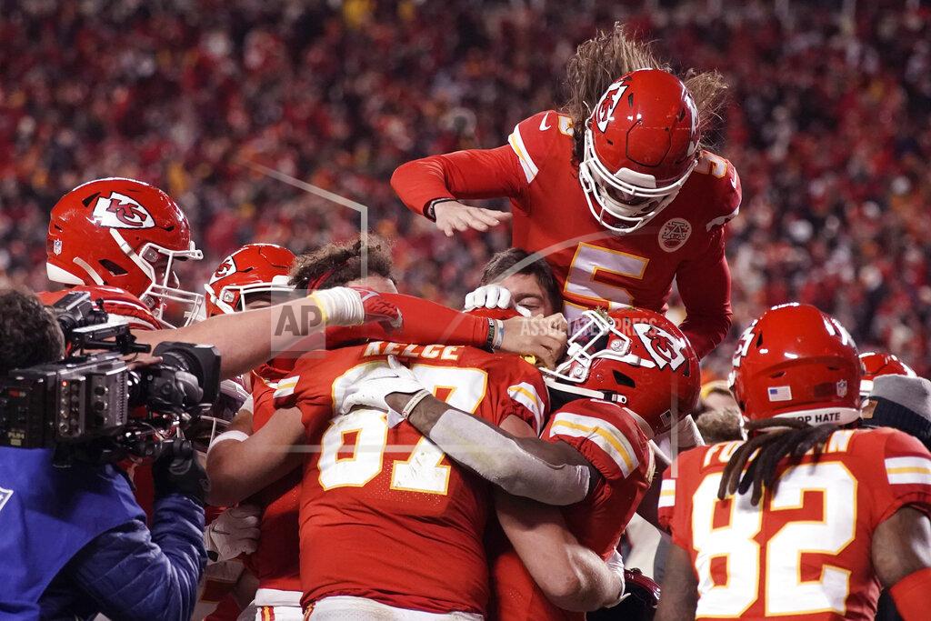 Charlie Riedel Kansas City Chiefs tight end Travis Kelce (87) celebrates with teammates after catching an 8-yard touchdown pass during overtime in an NFL divisional round playoff football game against the Buffalo Bills, Sunday, Jan. 23, 2022, in Kansas City, Mo. The Chiefs won 42-36. (AP Photo/Charlie Riedel)