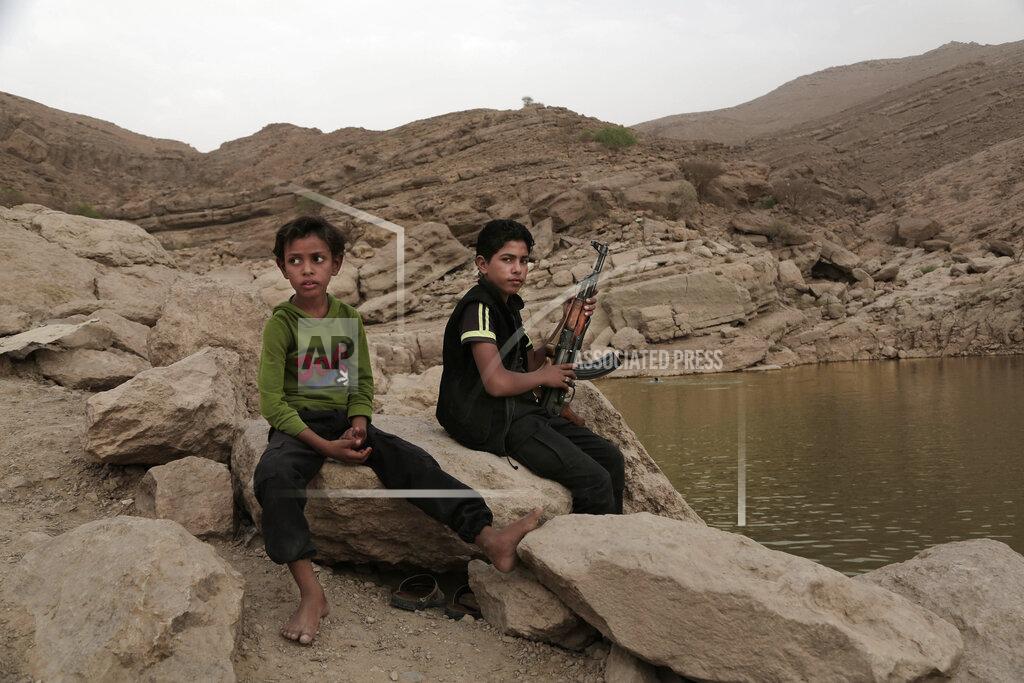 Nariman El-Mofty FILE - In this July 30, 2018, file photo, a 17-year-old boy holds his weapon at the dam in Marib, Yemen. The battle for the ancient desert city has become key to understanding wider tensions now inflaming the Middle East and the challenges facing any efforts by President Joe Biden’s administration to shift U.S. troops out of the region. (AP Photo/Nariman El-Mofty, File)