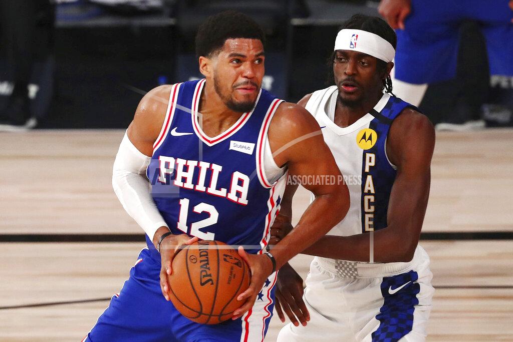 Kim Klement Philadelphia 76ers forward Tobias Harris (12) drives to the basket against against Indiana Pacers forward Justin Holiday (8) during the fourth quarter of an NBA basketball game Saturday, Aug. 1, 2020, in Lake Buena Vista, Fla. (Kim Klement/Pool Photo via AP)