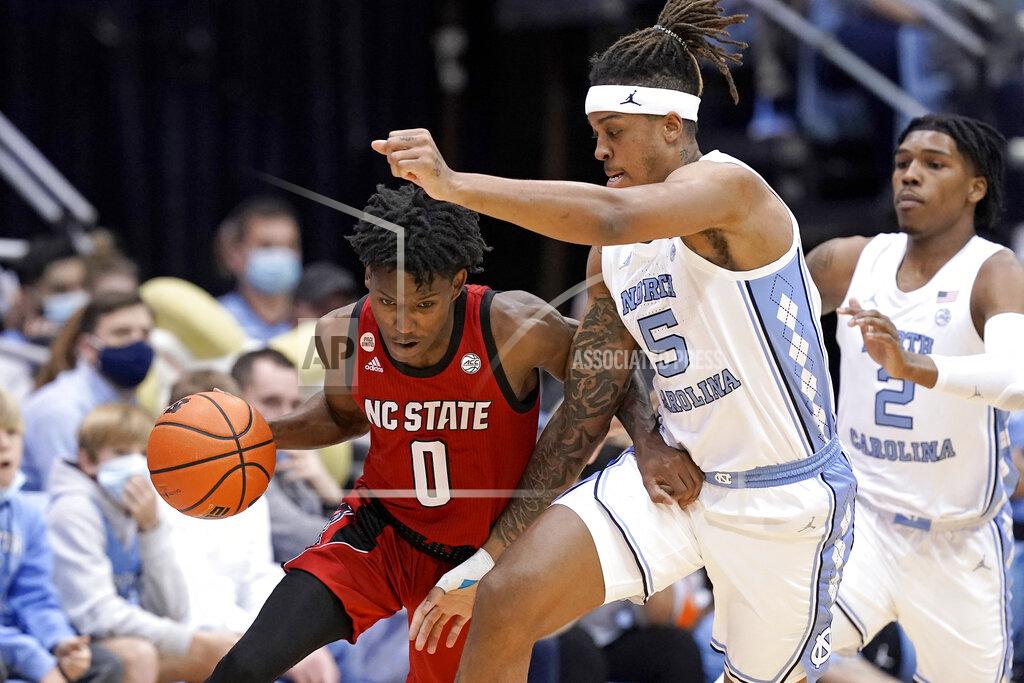 Gerry Broome North Carolina forward Armando Bacot (5) defends against North Carolina State guard Terquavion Smith (0) during the first half of an NCAA college basketball game in Chapel Hill, N.C., Saturday, Jan. 29, 2022. (AP Photo/Gerry Broome)