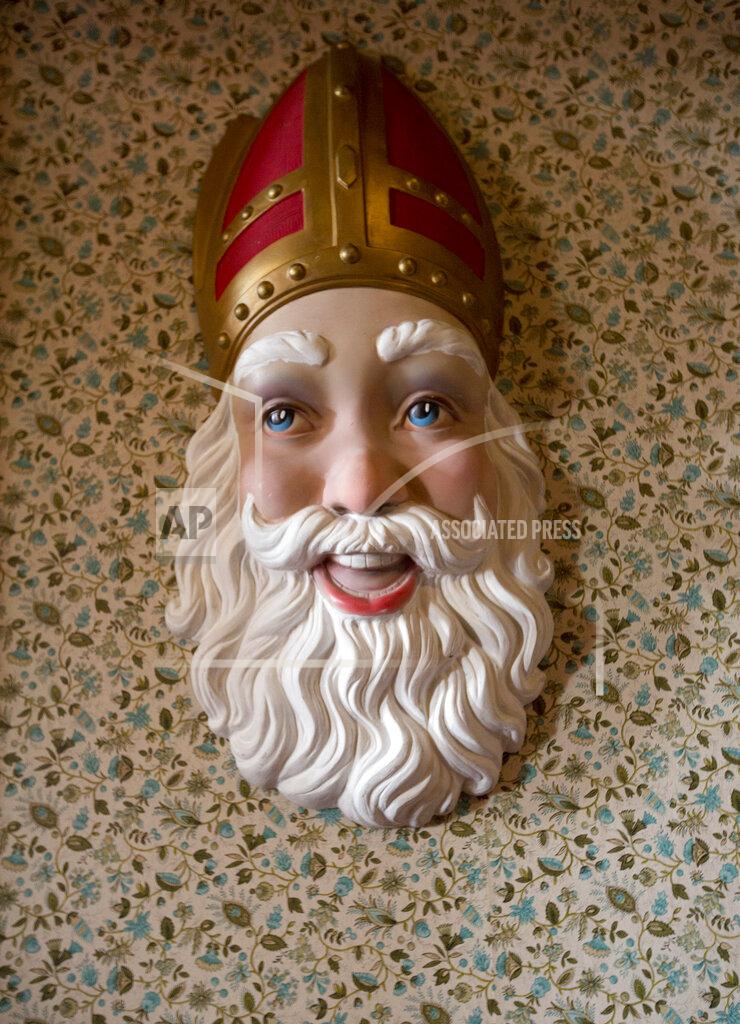 FILE - In this Thursday, Nov. 13, 2014 file photo, a plaster cast adorns a wall at the House of Saint Nicolas in the village of Sint-Niklaas, Belgium. To ensure the merriment of millions of Belgian kids this year, the government is offering a special exemption from the stringent coronavirus measures to beloved Saint Nicholas, who always delivers bountiful presents on the morning of Dec. 6. (AP Photo/Virginia Mayo, File)