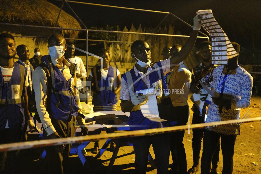 Electoral commission officials count the ballots after polls closed in Accra, Ghana, Monday, Dec. 7, 2020. Voters lined up early in Ghana to cast their ballots in presidential and legislative elections likely to test the West African nation's credentials as one of the most politically stable countries on the continent. (AP Photo/Ofoe Amegavie)