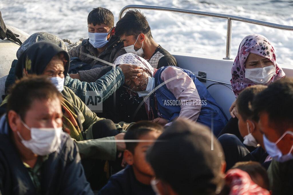 Emrah Gurel Migrants sit on a Turkish coast guard vessel after they were pulled off life rafts, during a rescue operation in the Aegean Sea, between Turkey and Greece, Saturday, Sept. 12, 2020. Turkey is accusing Greece of large-scale pushbacks at sea — summary deportations without access to asylum procedures, in violation of international law. The Turkish coast guard says it rescued over 300 migrants "pushed back by Greek elements to Turkish waters" this month alone. Greece denies the allegations and accuses Ankara of weaponizing migrants. (AP Photo/Emrah Gurel)