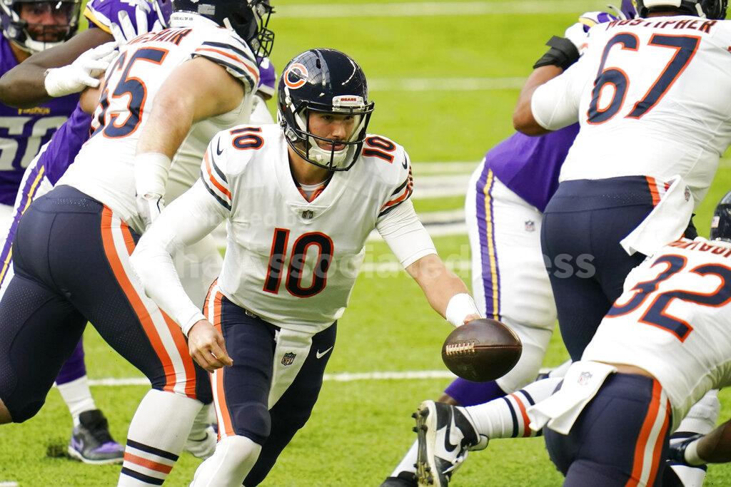 Chicago Bears quarterback Mitchell Trubisky (10) looks to hand the ball off during the first half of an NFL football game against the Minnesota Vikings, Sunday, Dec. 20, 2020, in Minneapolis. (AP Photo/Jim Mone)