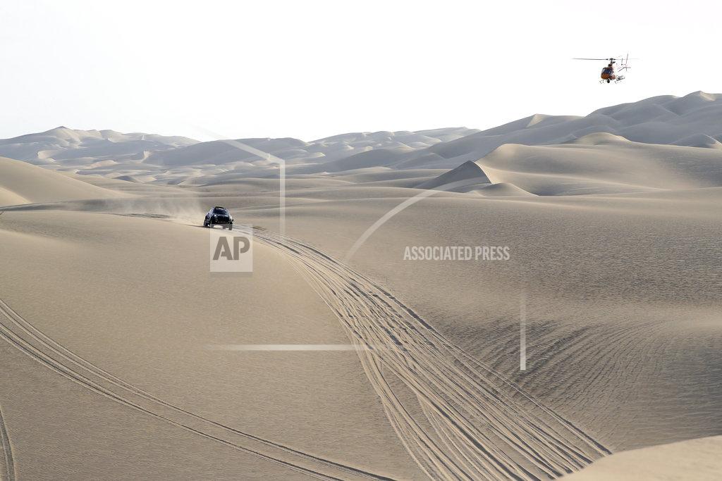 Ricardo Mazalan Driver Nani Roma, of Spain, and co-driver Alex Haro, of Spain, race their Mini during the second stage of the Dakar Rally between Pisco and San Juan de Marcona, Peru, Tuesday, Jan. 8, 2019. (AP Photo/Ricardo Mazalan)