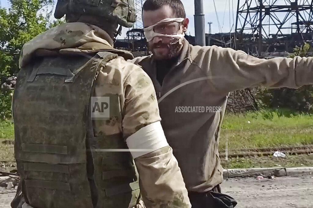 Uncredited In this photo taken from a video released by the Russian Defense Ministry Press Service on Wednesday, May 18, 2022, a Russian serviceman frisks a Ukrainian soldier after he left the besieged Azovstal steel plant in Mariupol, Ukraine. (Russian Defense Ministry Press Service via AP)