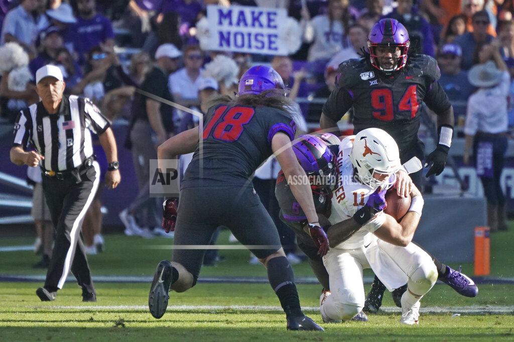 Louis Deluca Texas quarterback Sam Ehlinger (11) is tackled by TCU safety Innis Gaines (6) in the second half of an NCAA college football game in Fort Worth, Texas, Saturday, Oct. 26, 2019. (AP Photo/Louis DeLuca)