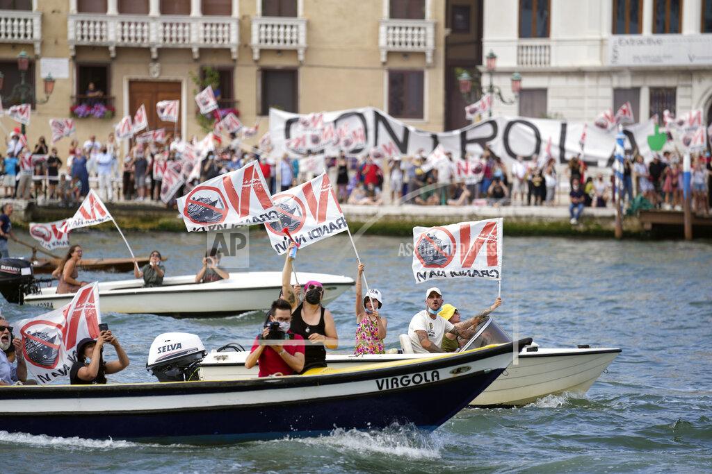 Antonio Calanni "No Big Ships" activists stage a protest as the MSC Orchestra cruise ship leaves Venice, Italy, Saturday, June 5, 2021. The 92,409-ton, 16-deck MSC Orchestra cruise ship, the first cruise ship leaving Venice since the pandemic is set to depart Saturday amid protests by activists demanding that the enormous ships be permanently rerouted out the fragile lagoon, especially Giudecca Canal through the city's historic center, due to environmental and safety risks. The ship passed two groups of protesters: pro-cruise advocates whose jobs depend on the industry as well as protesters who have been campaigning for years to get cruise ships out of the lagoon. (AP Photo/Antonio Calanni)