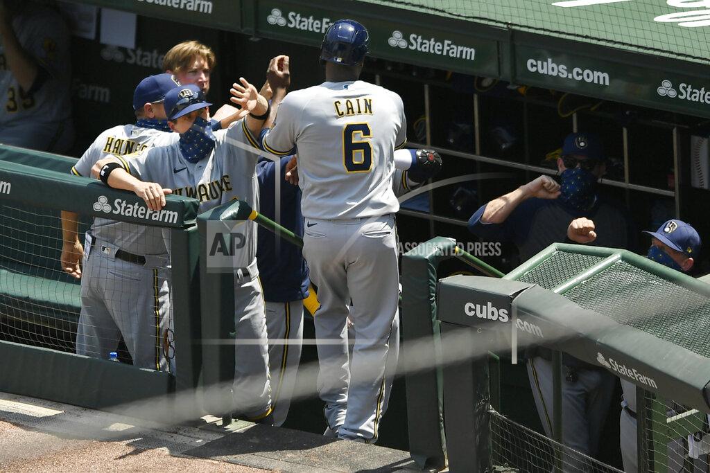 Paul Beaty Milwaukee Brewers manager Craig Counsell left, celebrates with Lorenzo Cain (6) after he scored one a Eric Sogard single during the second inning of a baseball game against the Chicago Cubs Saturday, July 25, 2020, in Chicago. (AP Photo/Paul Beaty)