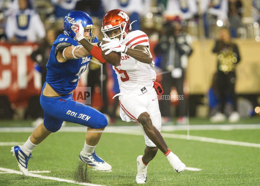 Brett Rojo Tulsa defensive end Cullen Wick, left, tries to tackle Houston wide receiver Marquez Stevenson during an NCAA college football game Saturday, Nov. 23, 2019, in Tulsa, Okla. (Brett Rojo/Tulsa World via AP)