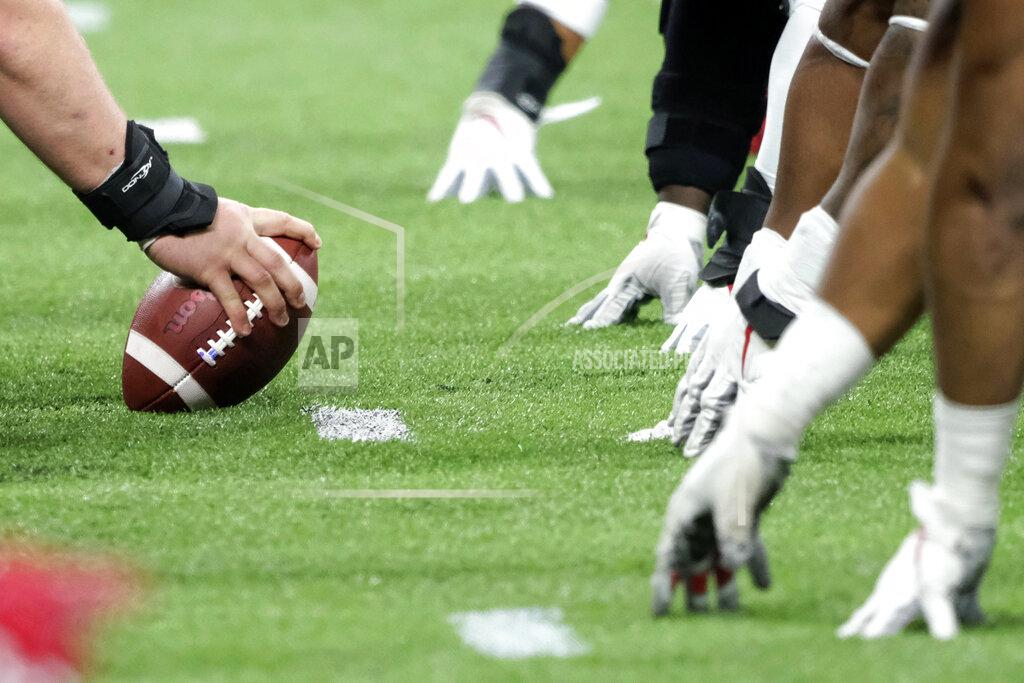 FILE - In this Dec. 7, 2019, file photo, a player prepares to hike the ball at the line of scrimmage during the first half of the Big Ten championship NCAA college football game between Ohio State and Wisconsin in Indianapolis. Don Yee, one of sports' most influential agents, Tom Brady is one of his clients, has teamed with former ESPN and NFL Network executive Jamie Hemann to develop HUB Football. The concept is simple, though the implementation could be very complex: It will provide opportunities for college players and street free agents to be seen in action by NFL teams.
(AP Photo/AJ Mast, File)