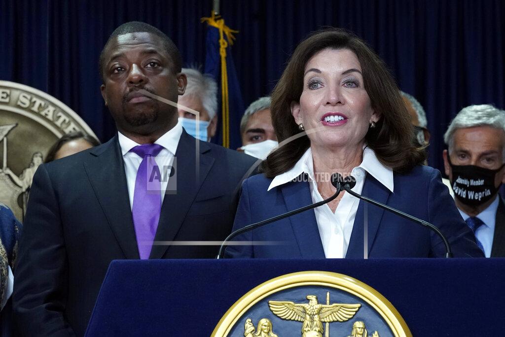 Richard Drew New York Gov. Kathy Hochul, accompanied by Lt. Gov. Brian Benjamin, left, speaks before signing the "Less is More" law, during ceremonies in the governor's office, in New York, Friday, Sept. 17, 2021. New Yorkers will be able to avoid jail time for most nonviolent parole violations under a new law that will take effect in March, and largely eliminates New York's practice of incarcerating people for technical parole violations. (AP Photo/Richard Drew)