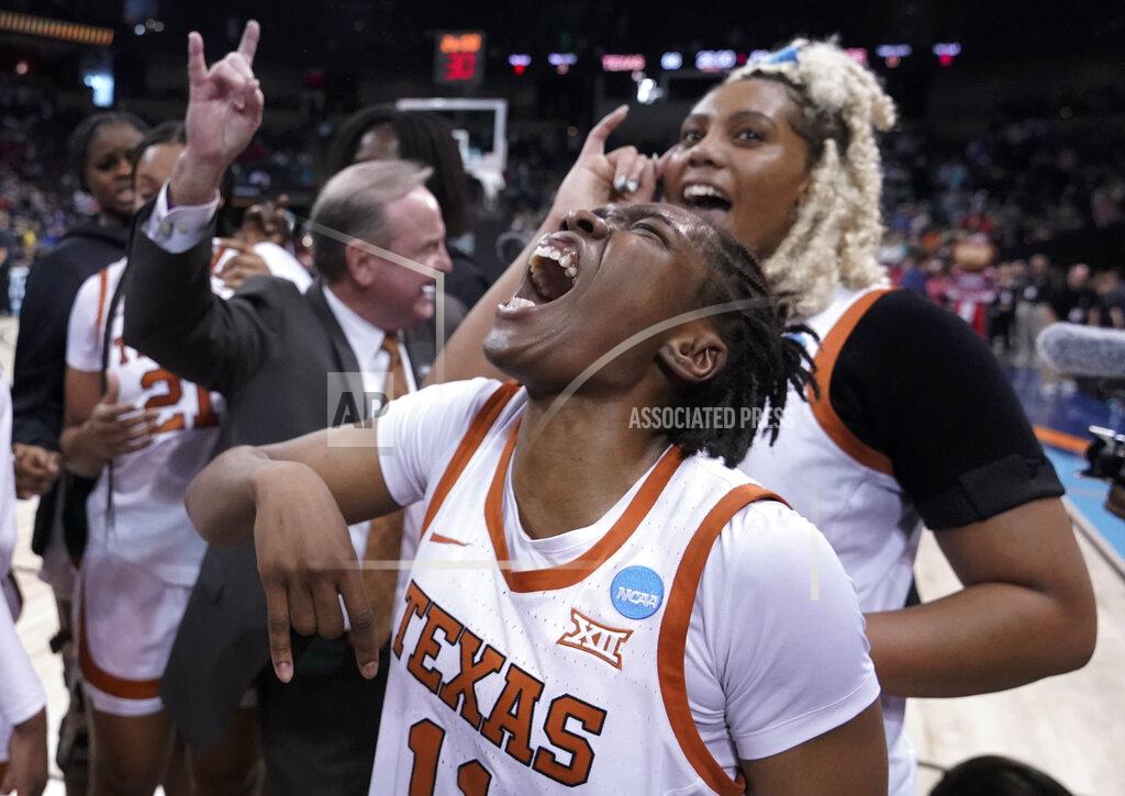 Ted S. Warren Texas guard Joanne Allen-Taylor, center, reacts after Texas beat Ohio State 66-63 in a college basketball game in the Sweet 16 round of the NCAA tournament, Friday, March 25, 2022, in Spokane, Wash. (AP Photo/Ted S. Warren)