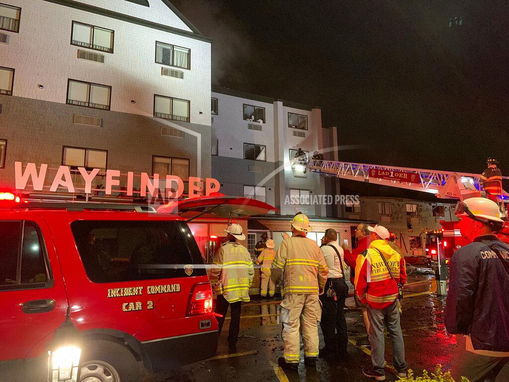 Scott Barrett Firefighters battle a fire at a recently renovated hotel in Newport, R.I., Monday, May 23, 2022. Three firefighters were injured battling the fire at the Wayfinder Hotel. (Scott Barrett/The Newport Daily News via AP)