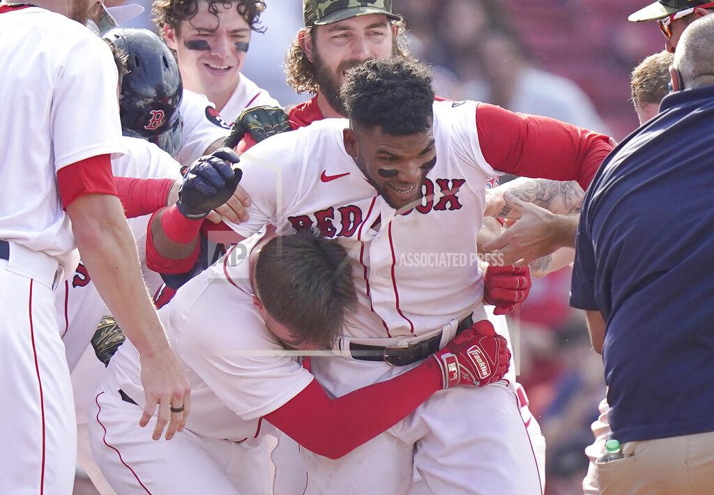 Steven Senne Boston Red Sox's Franchy Cordero, center, celebrates with teammates after hitting a grand slam in the tenth inning of a baseball game against the Seattle Mariners, Sunday, May 22, 2022, in Boston. The Red Sox won 8-4. (AP Photo/Steven Senne)