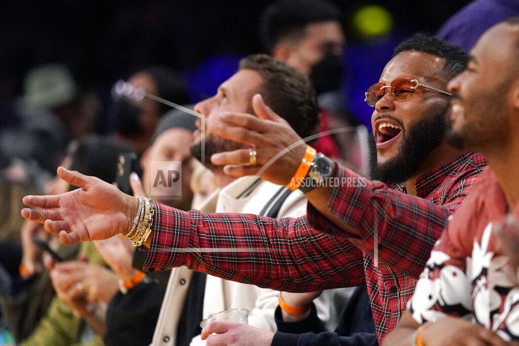Mark J. Terrill Aaron Donald of the Los Angeles Rams celebrates during the second half of an NBA basketball game between the Los Angeles Lakers and the Utah Jazz Wednesday, Feb. 16, 2022, in Los Angeles. The Lakers won 106-101. (AP Photo/Mark J. Terrill)