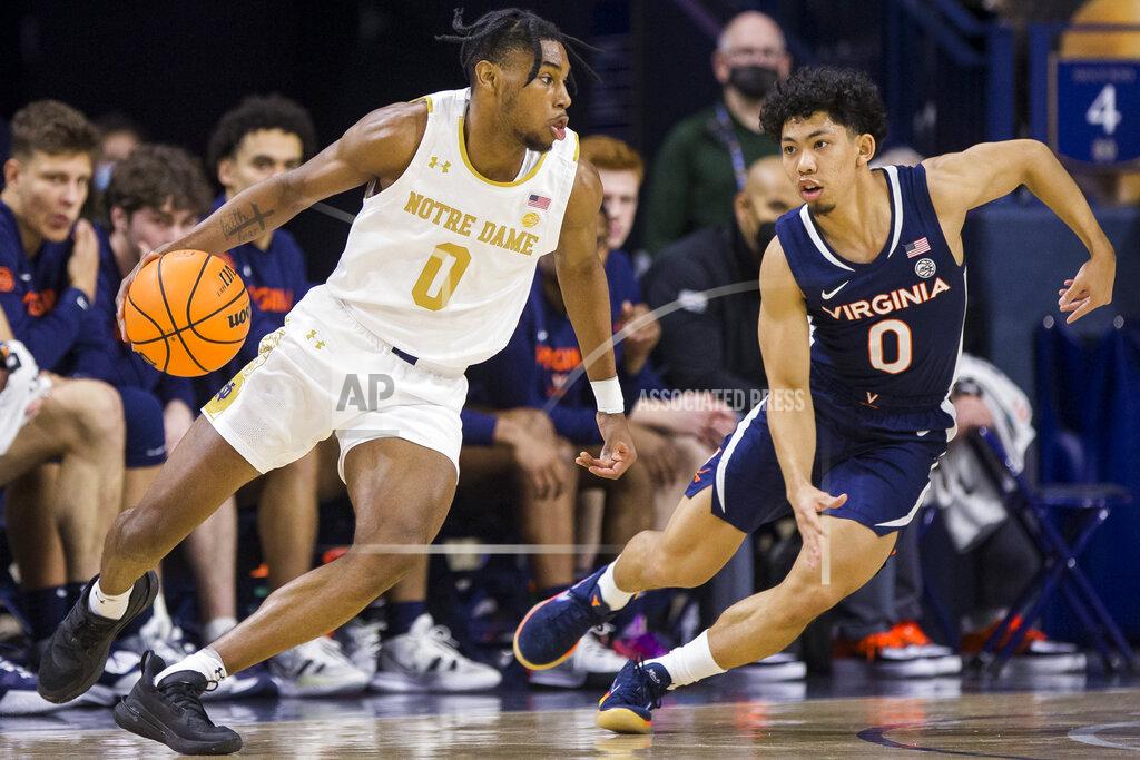 Robert Franklin Notre Dame's Blake Wesley, left, drives in next to Virginia's Kihei Clark during the first half of an NCAA college basketball game Saturday, Jan. 29, 2022, in South Bend, Ind. (AP Photo/Robert Franklin)