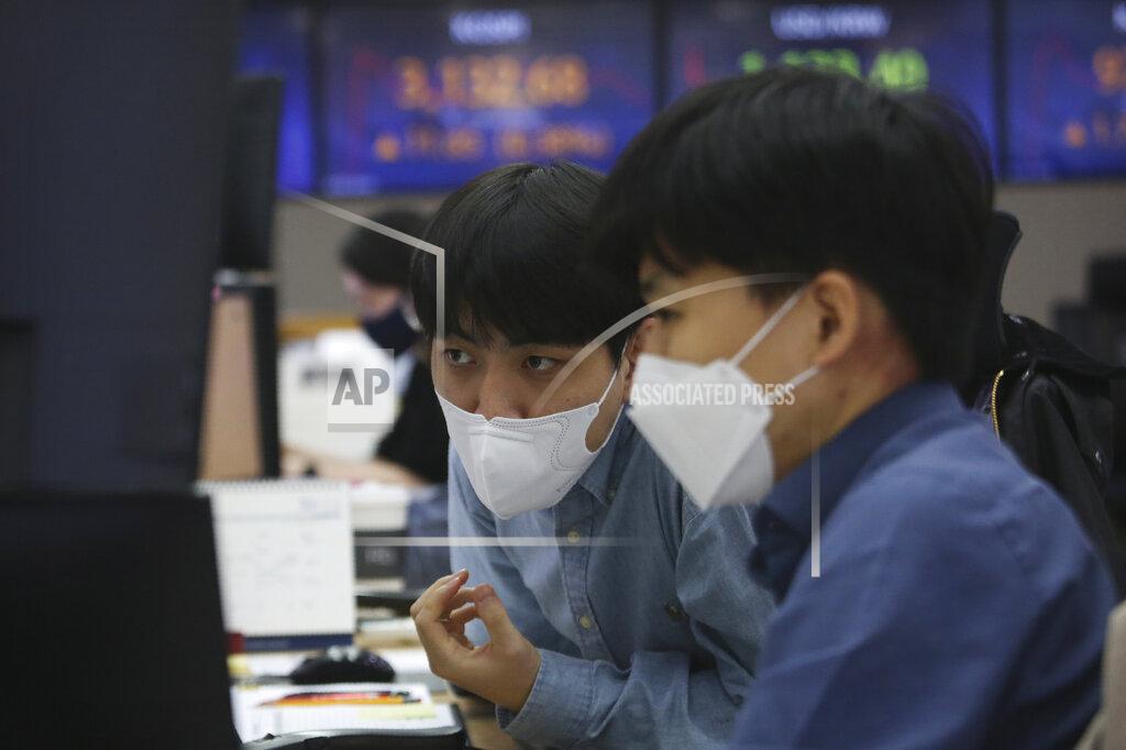Ahn Young-Joon Currency traders wearing face masks watch monitors at the foreign exchange dealing room of the KEB Hana Bank headquarters in Seoul, South Korea, Tuesday, April 6, 2021. Asian shares were mixed Tuesday after a Wall Street rally that reflected some optimism about the economy recovering from the damage of the coronavirus pandemic. (AP Photo/Ahn Young-joon)