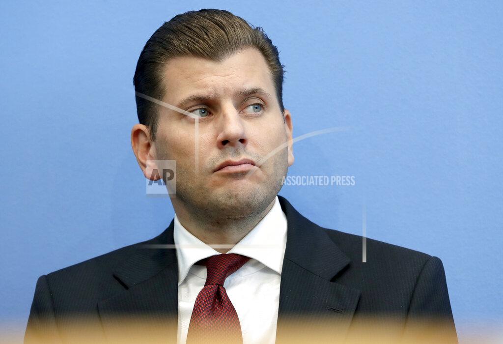FILE - In this Monday, Oct. 15, 2018 file photo Christian Lueth of the Alternative for Germany party attends a press conference in Berlin, Germany, the day after the state elections in the German state of Bavaria. The far-right Alternative for Germany party confirmed Monday Sept. 28, 2020, they have fired Christian Lueth, following reports that he made comments suggesting that migrants could be killed. (AP Photo/Michael Sohn, file)