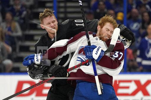 Tampa Bay Lightning right wing Corey Perry (10) and Colorado Avalanche left wing J.T. Compher (37) scrap during the second period of an NHL hockey game Saturday, Oct. 23, 2021, in Tampa, Fla. (AP Photo/Chris O'Meara)