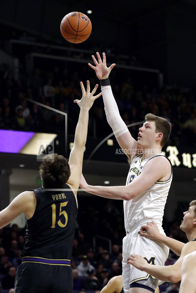 Nam Y. Huh Michigan center Jon Teske, right, shoots over Northwestern center Ryan Young during the first half of an NCAA college basketball game in Evanston, Ill., Wednesday, Feb. 12, 2020. (AP Photo/Nam Y. Huh)