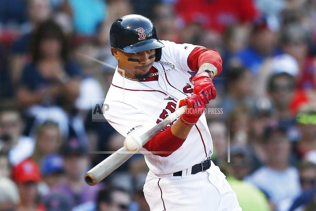 FILE - In this Aug. 10, 2019, file photo, Boston Red Sox's Mookie Betts hits an RBI-double during the sixth inning of a baseball game against the Los Angeles Angels in Boston. Betts has agreed to a $27 million contract with the Red Sox. It is the largest one-year salary for an arbitration-eligible player. (AP Photo/Michael Dwyer, File)