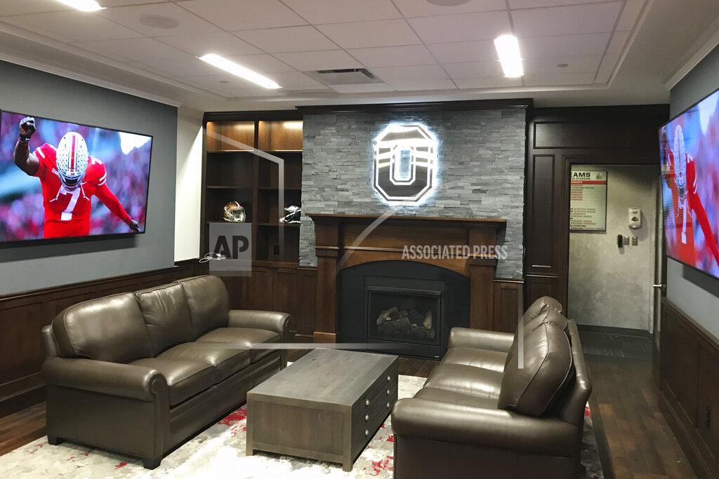 This Saturday, Aug. 23, 2019, photo provided by Ohio State Athletics shows the NCAA college football head coach's office at the Woody Hayes Center on the Ohio State campus in Columbus, Ohio. The head coach's office is right off the locker room. A player could step out of one and right into the other. To encourage the Buckeyes to do just that, Ryan Day made a few changes to the space since taking over for Urban Meyer. (Jerry Emig/Ohio State Athletics via AP)