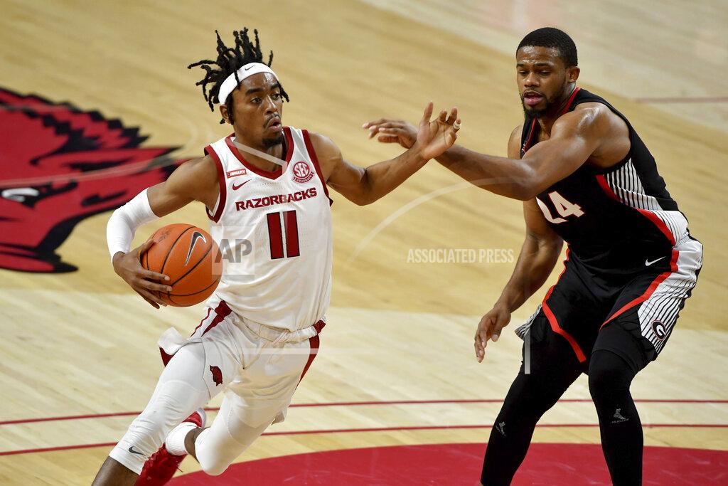 Michael Woods Arkansas guard Jalen Tate (11) tries to drive past Georgia defender P.J. Horne (24) during the second half of an NCAA college basketball game Saturday, Jan. 9, 2021, in Fayetteville, Ark. (AP Photo/Michael Woods)