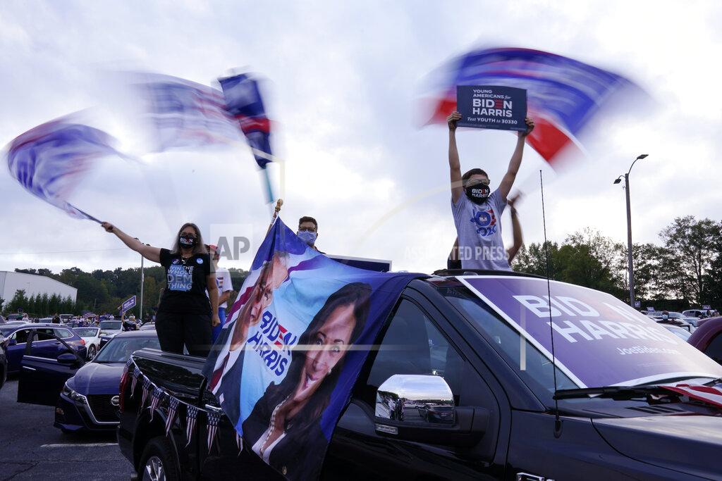 Andrew Harnik FILE - In this Oct. 27, 2020, file photo people listen during a drive-in rally for Democratic presidential candidate former Vice President Joe Biden at Cellairis Amphitheatre in Atlanta. (AP Photo/Andrew Harnik, File)