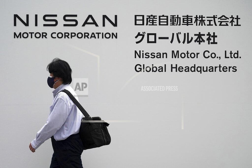Eugene Hoshiko A man walks in front of Nissan headquarters Thursday, May 12, 2022, in Yokohama near Tokyo. Japanese automaker Nissan returned to profitability in the last fiscal year for the first time in three years, despite challenges such as supply shortages caused by the pandemic and soaring costs. (AP Photo/Eugene Hoshiko)
