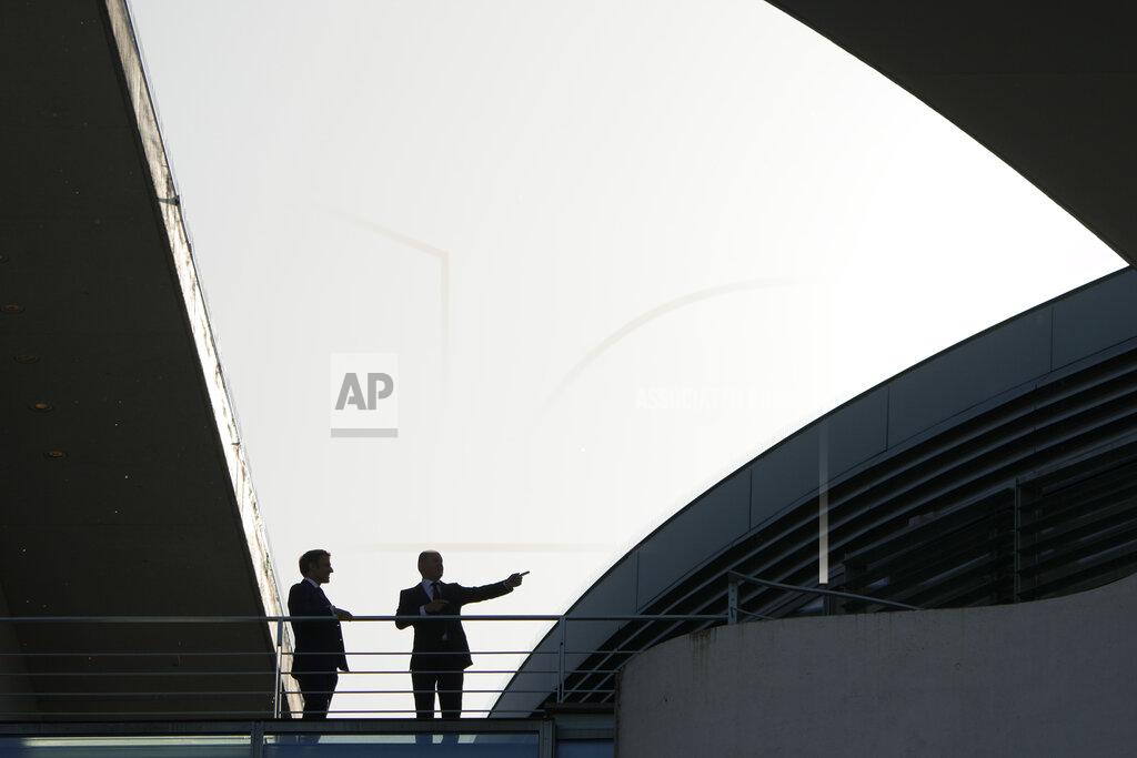 Markus Schreiber German Chancellor Olaf Scholz, right, talks with French President Emmanuel Macron, at the chancellery in Berlin, Germany, Monday, May 9, 2022. (AP Photo/Markus Schreiber)