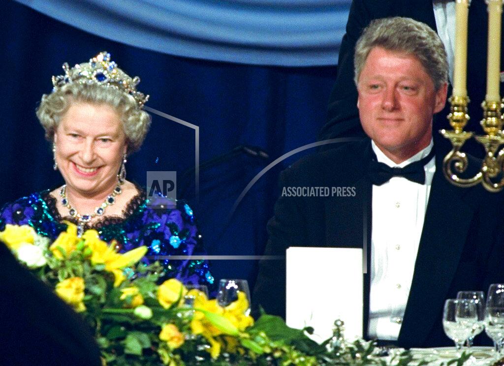 Doug Mills FILE - In this Saturday, June 4, 1994 file photo, Britain's Queen Elizabeth smiles, as she sits alongside President Bill Clinton at a dinner in the Guildhall in Portsmouth, England, commemorating the 50th anniversary of D-Day. (AP Photo/Doug Mills, File)